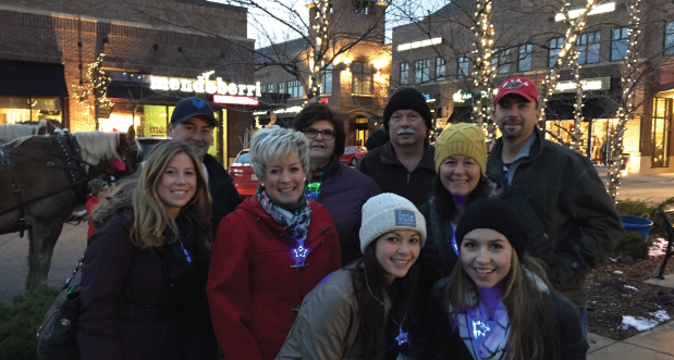 bank employees at volunteer event handing out glow necklaces