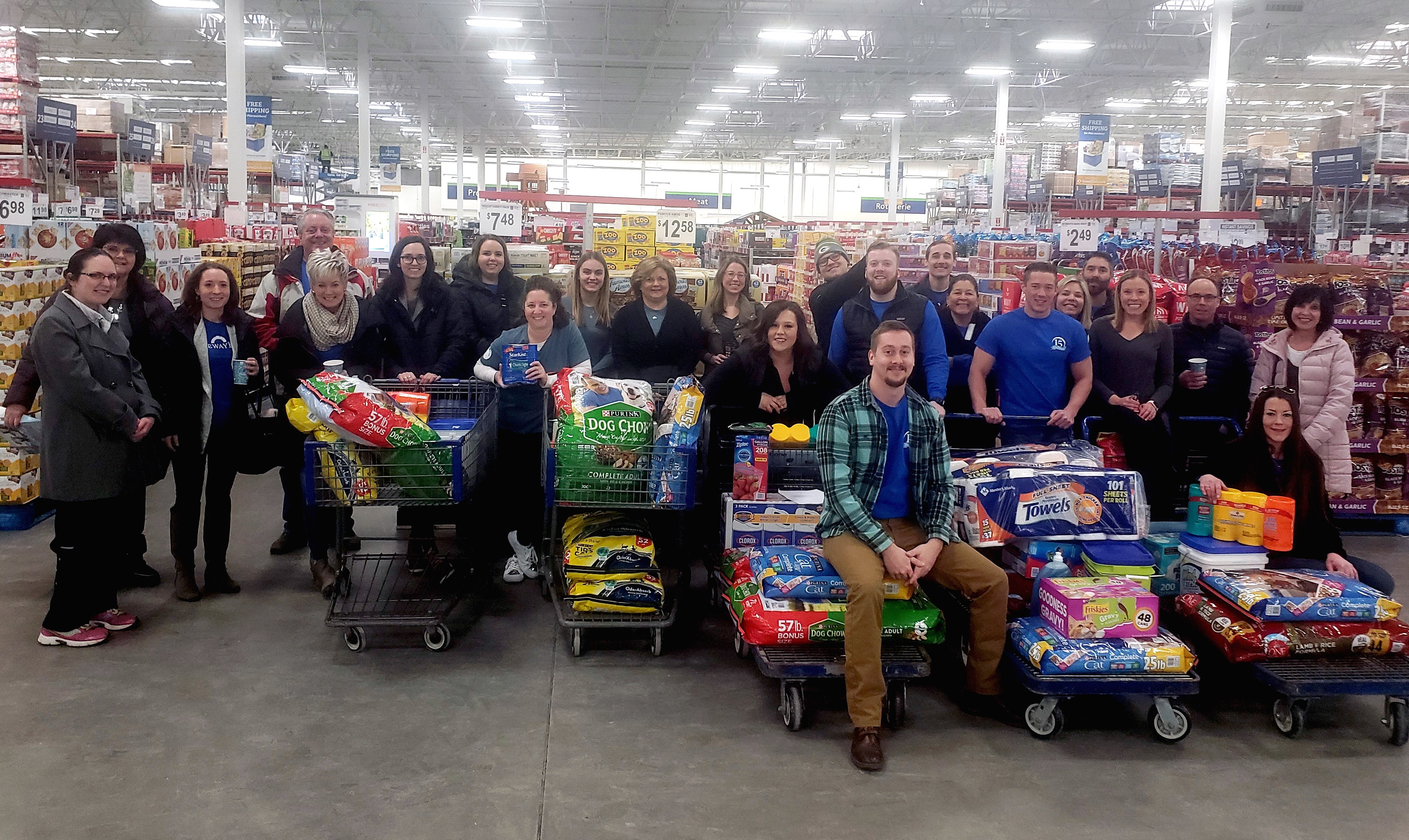 associates with carts full of supplies to be donated to the humane society during Bank Day as a part of the Gateway Gives program.